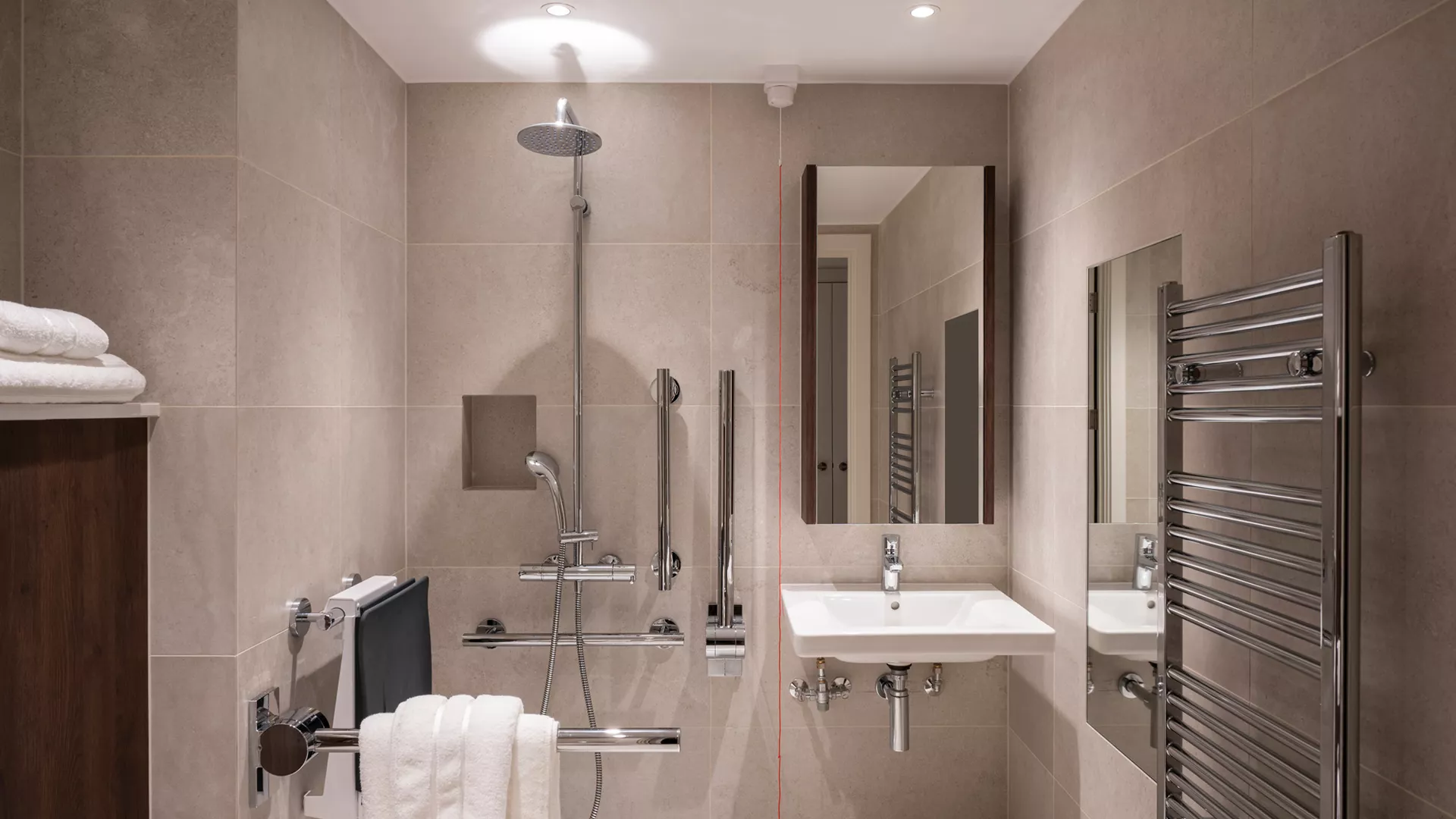 Accessible bathroom with level access shower and grab rails