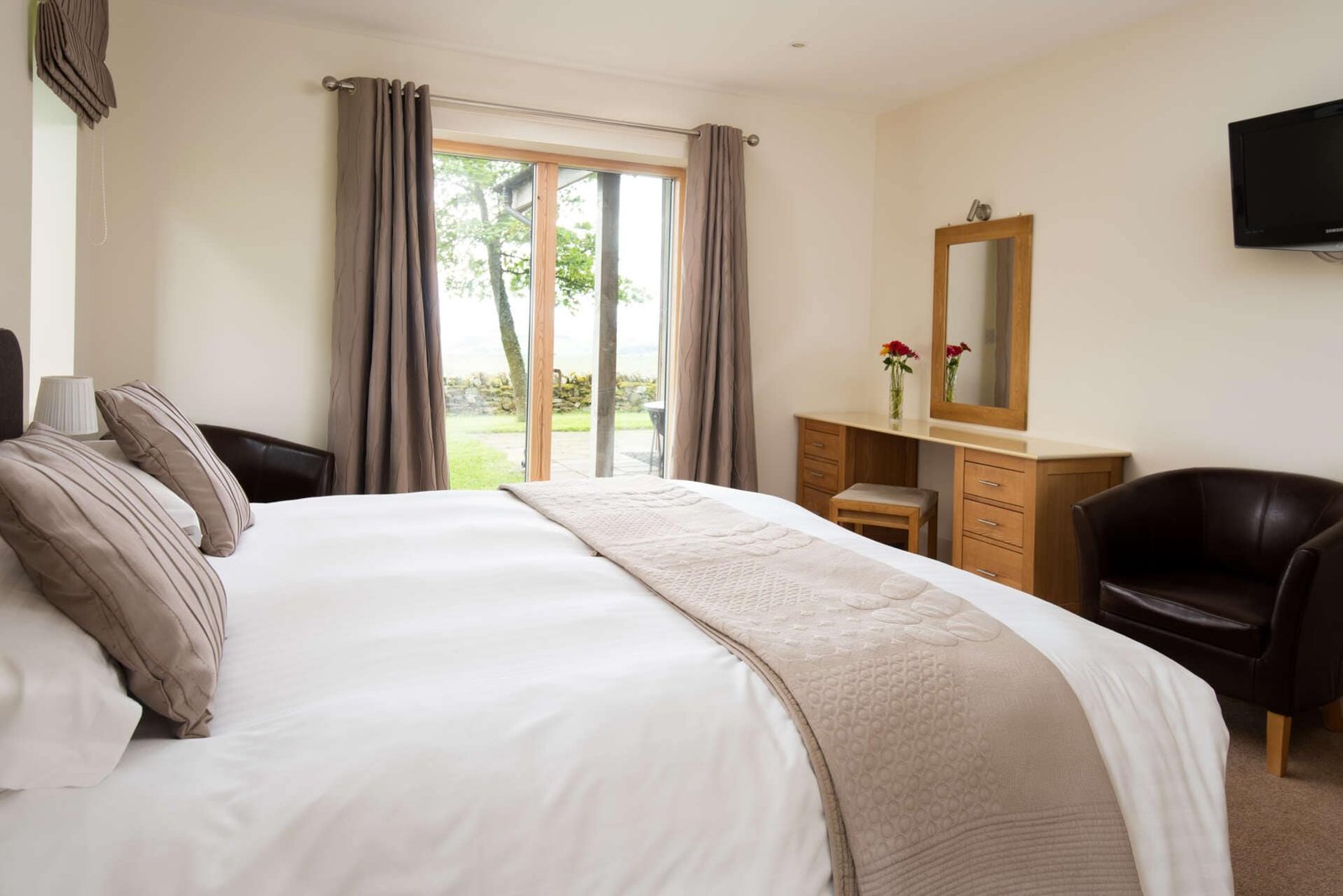 Elegant bedroom with lush view and modern decor.
