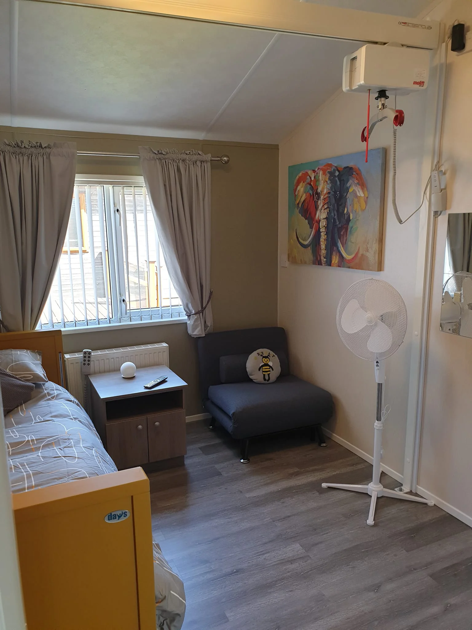 Accessible bedroom with single profiling bed, Z bed and celing mounted track hoist