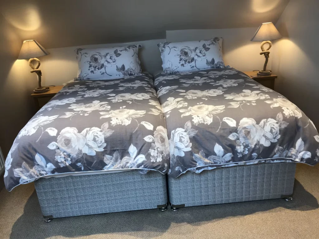 Twin/double beds with space to the side and foot of the bed