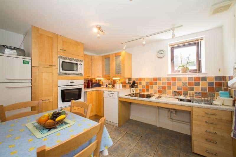 Bright kitchen with wooden cabinets and dining table