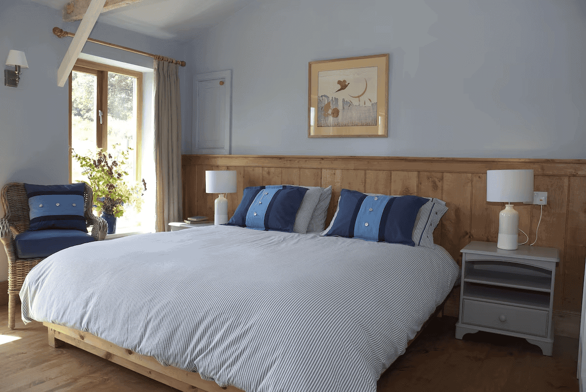 Cozy rustic bedroom with blue accents and wooden decor