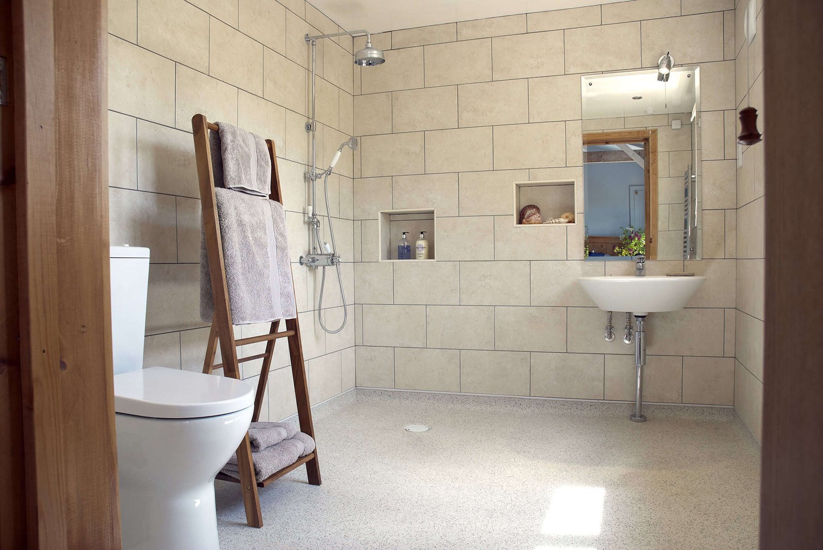 Modern bathroom interior with tiled walls and sunlight