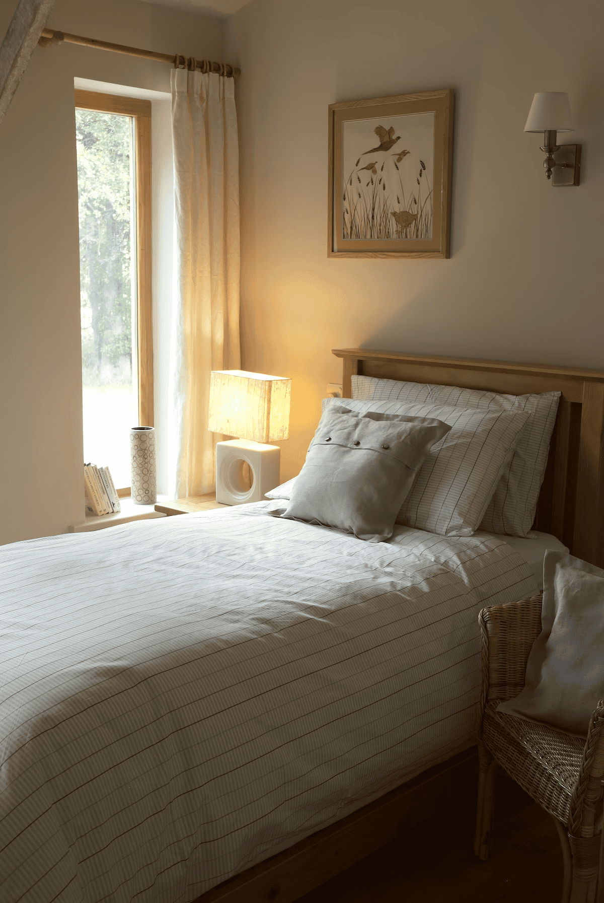 Cozy bedroom with natural light and wooden furniture