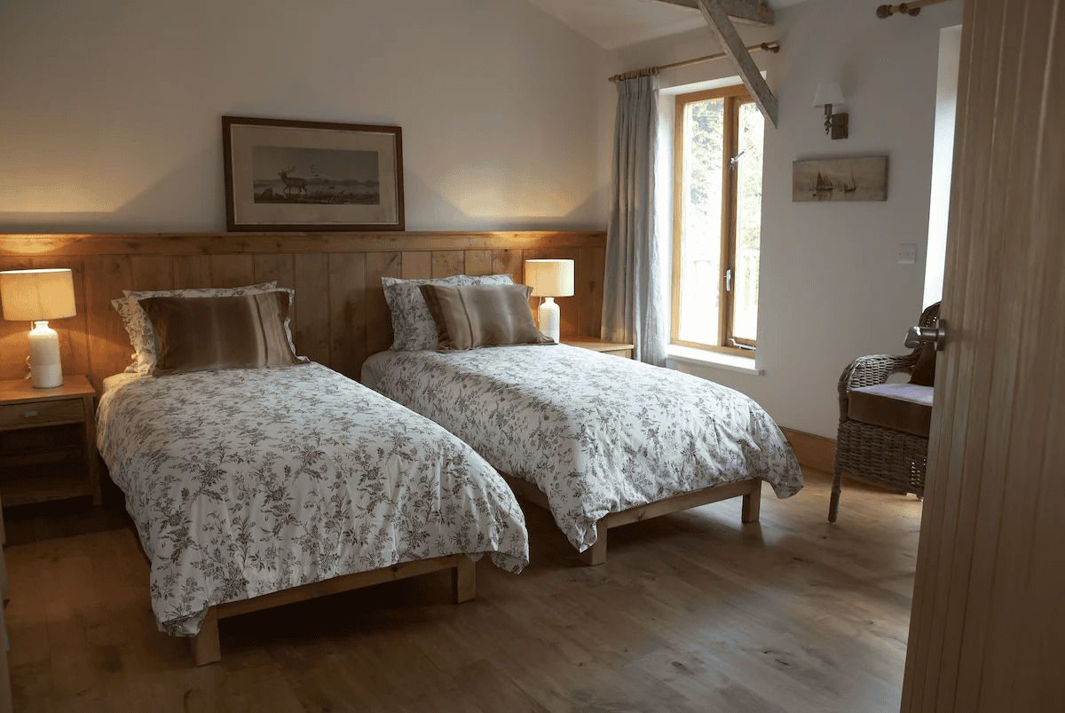 Cozy rustic bedroom with two twin beds and wooden decor