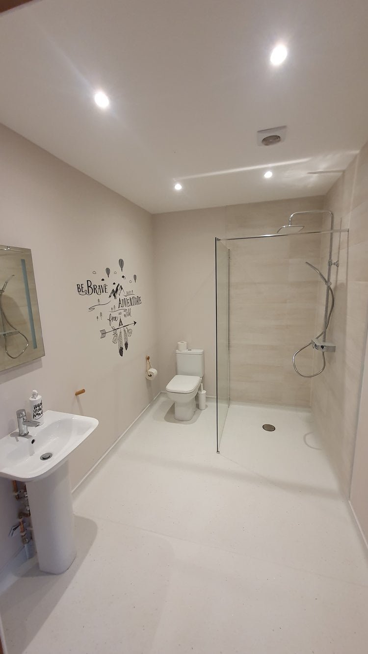 Modern bathroom with shower and inspirational wall art