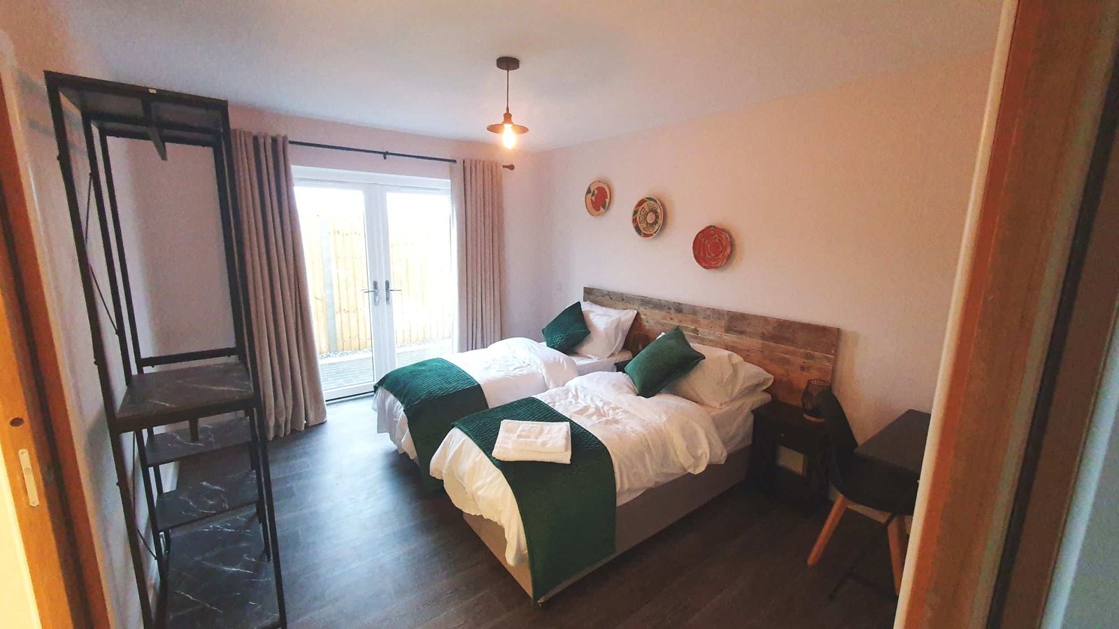 Cozy hotel room with twin beds and decorative plates