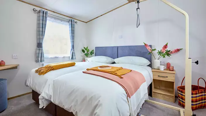 Cozy bedroom with blue headboard and colorful accents