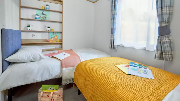 Bright child's bedroom with two beds and colorful decor