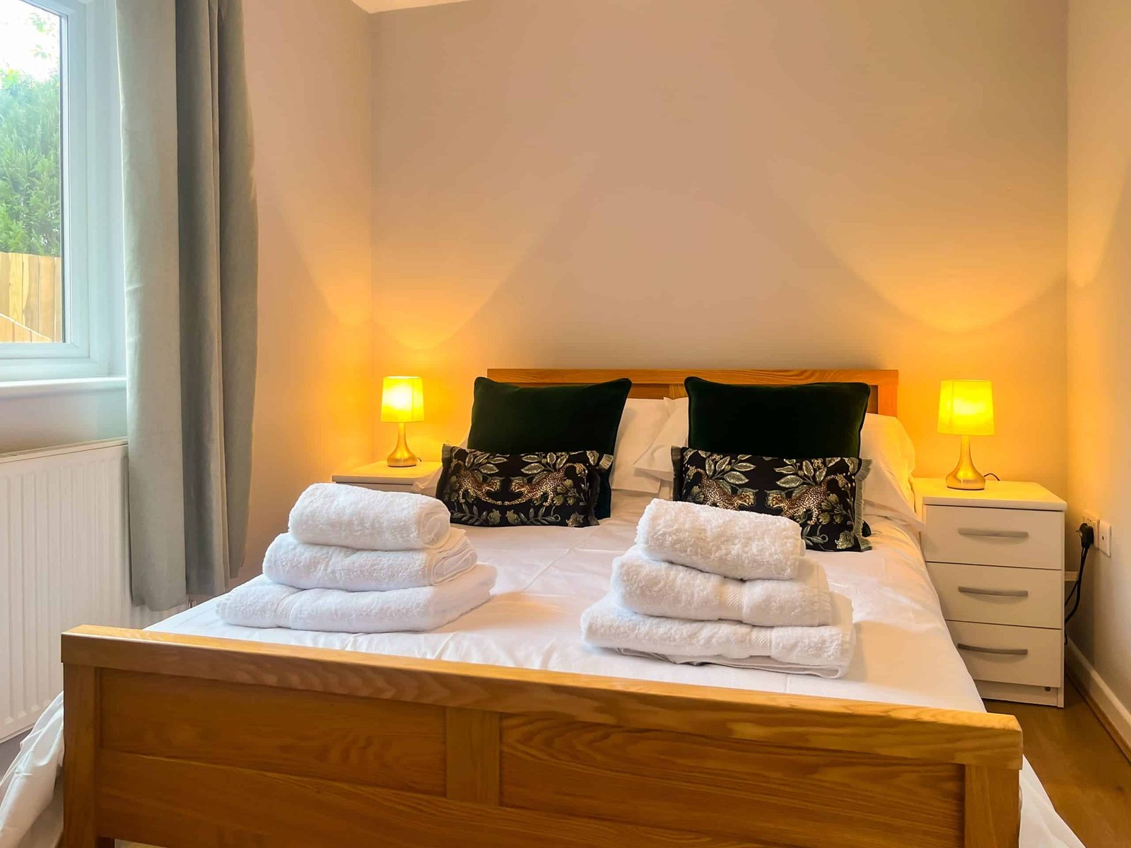 Cozy bedroom with neatly arranged bed and warm lighting
