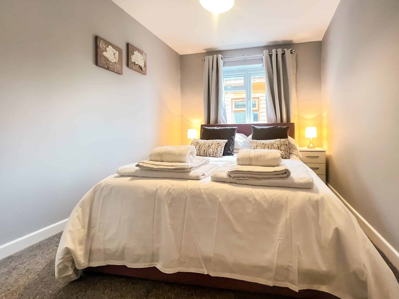 Cozy bedroom with tidy bed and warm lighting