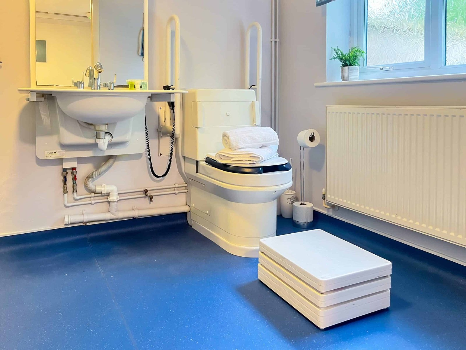 Accessible bathroom with safety rails and modern fixtures