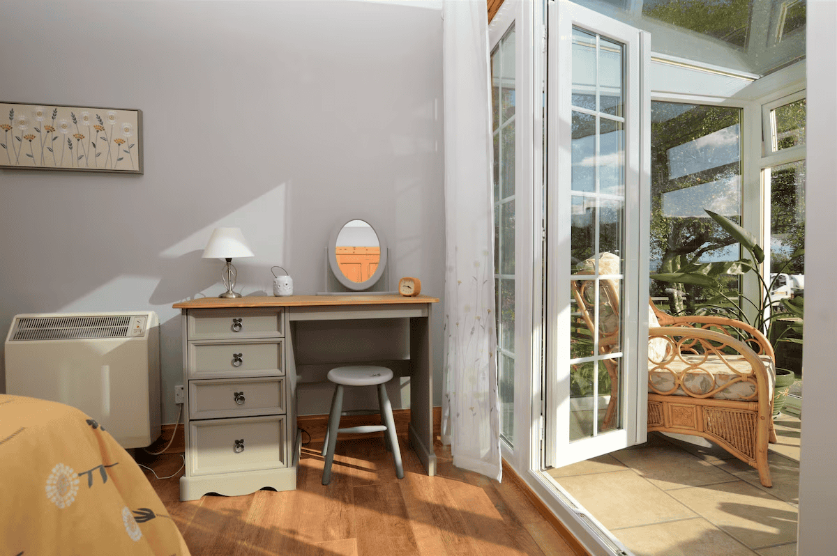 Sunny home office with open French doors and plants