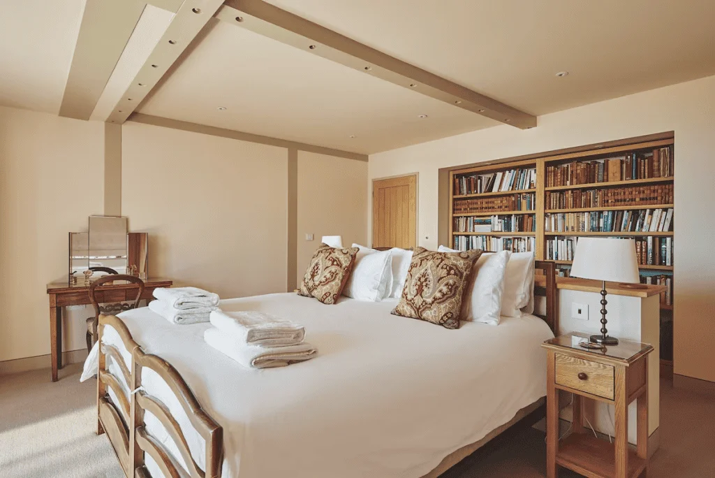 Cozy bedroom with large bed and extensive bookshelf