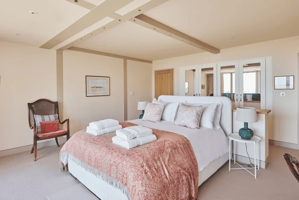 Spacious bedroom with large bed and elegant decor