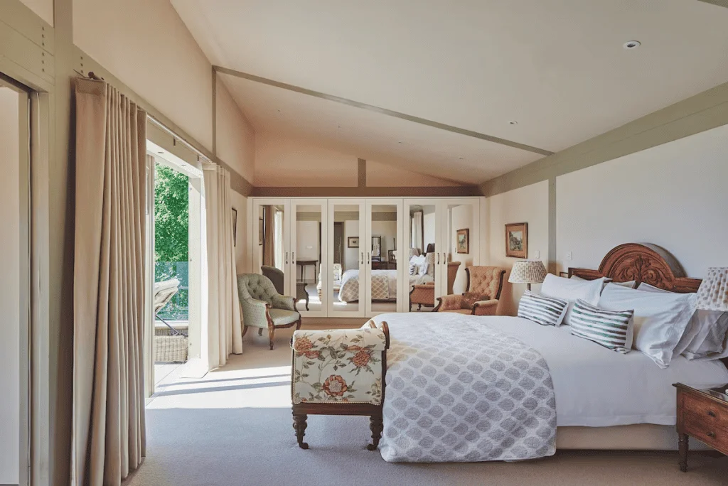 Elegant spacious bedroom with natural light and garden view