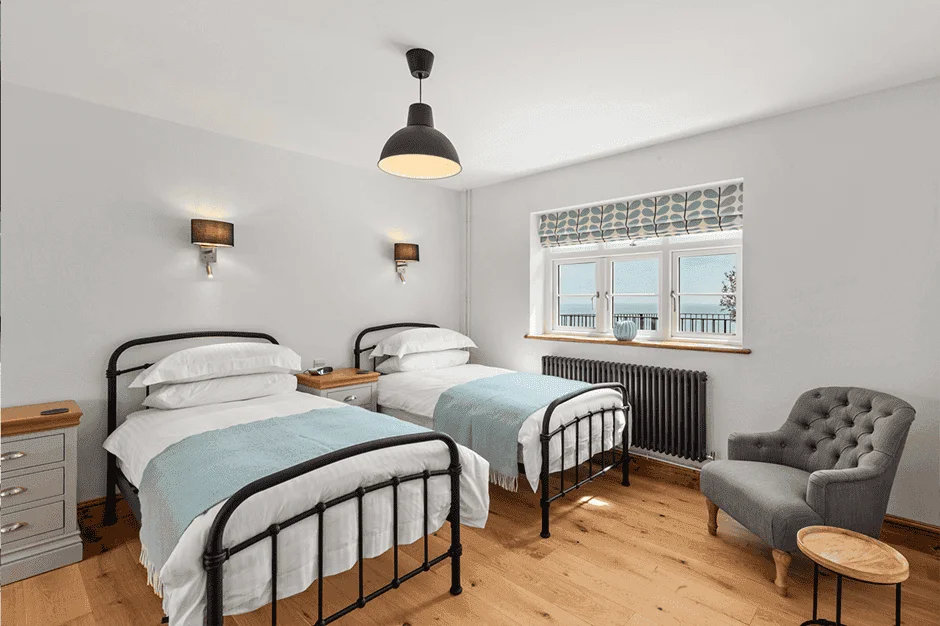 Bright twin bedroom with scenic window view