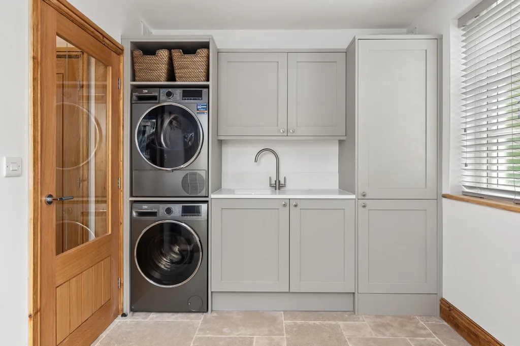 Modern laundry room with stacked washer and dryer