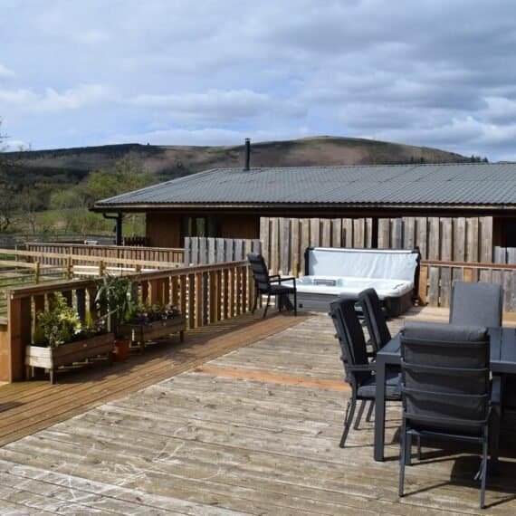 Wooden deck with hot tub overlooking mountains