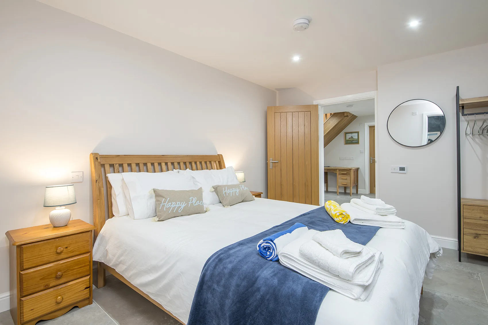 Bright, cozy bedroom with wooden furniture and decor