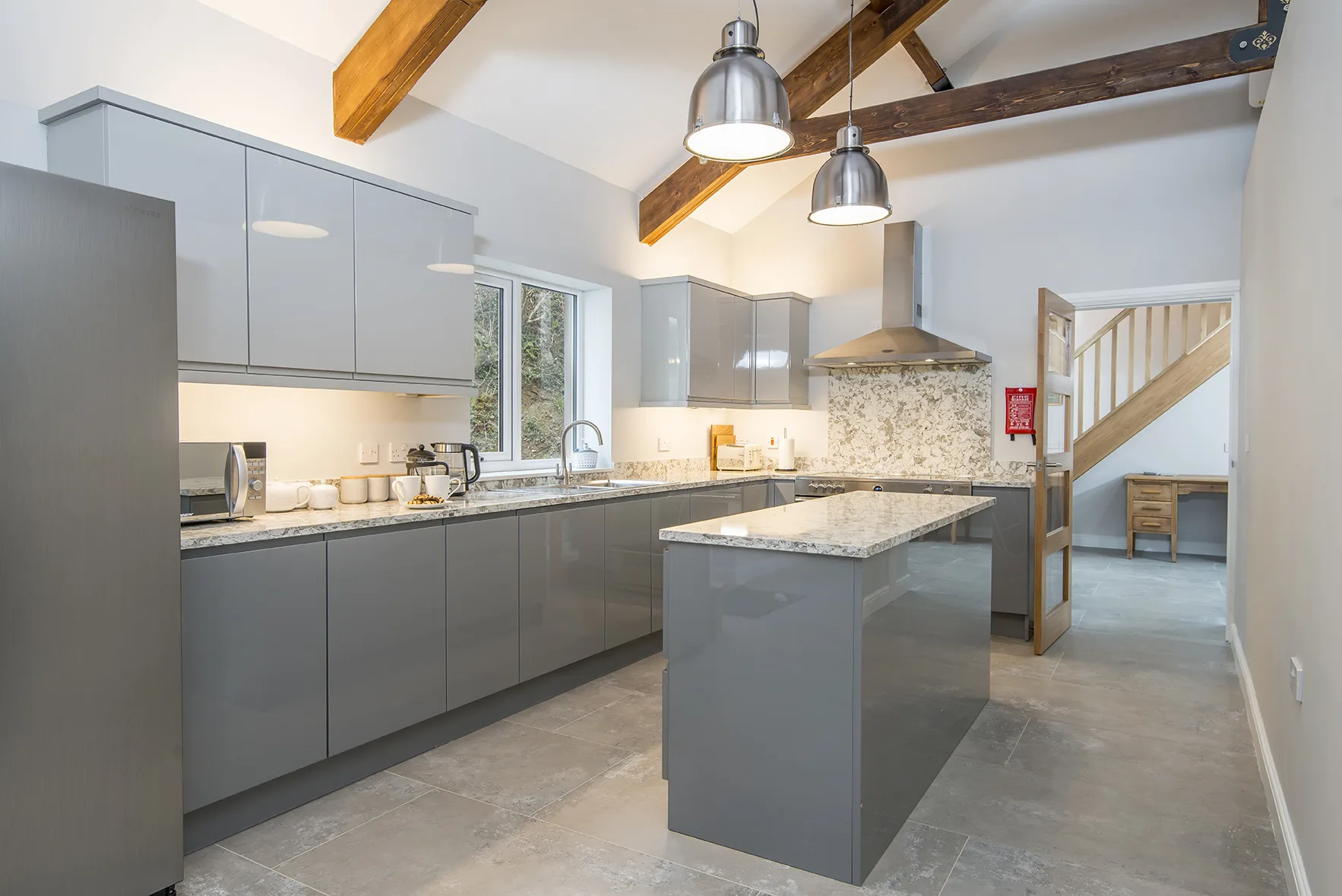 Modern kitchen with wooden beams and granite countertops