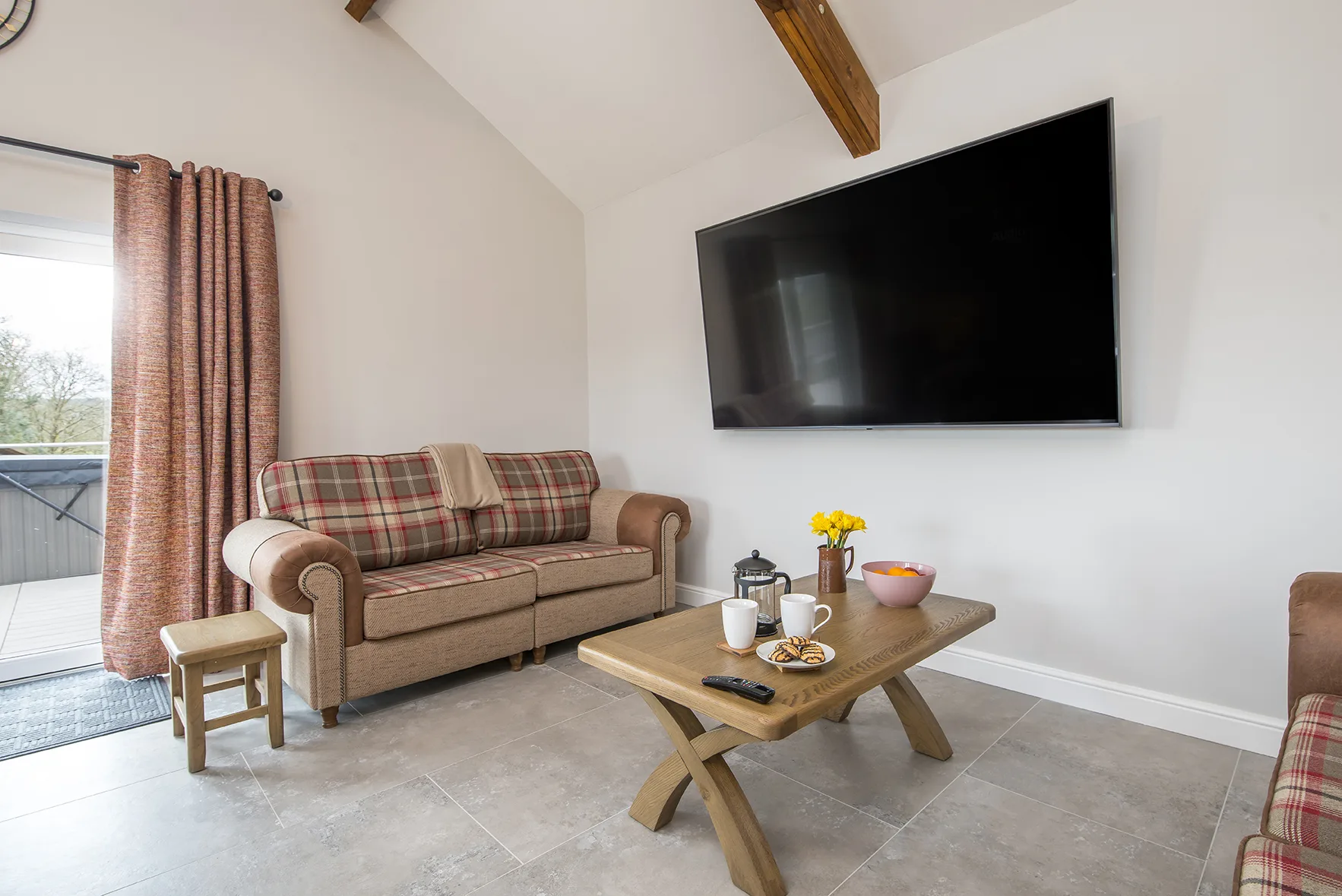 Cozy living room with TV and plaid sofa