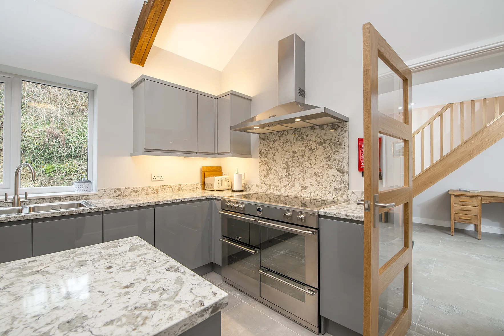 Modern kitchen with stainless appliances and marble countertop