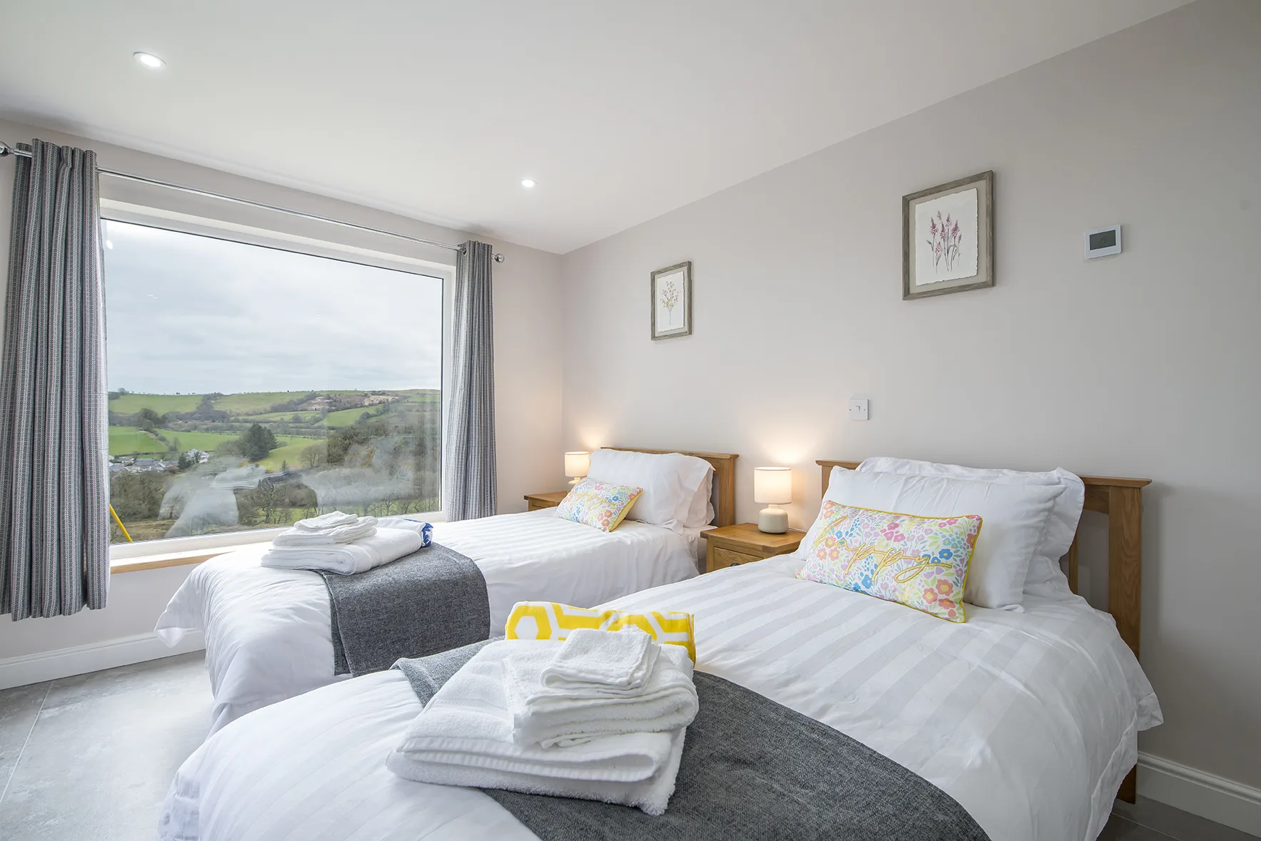 Bright bedroom with scenic countryside view through window