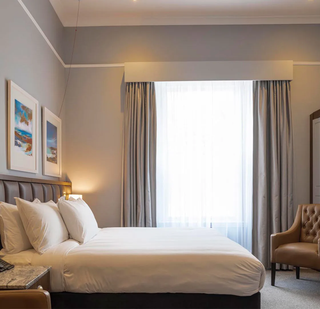 Elegant bedroom with plush bedding and serene decor