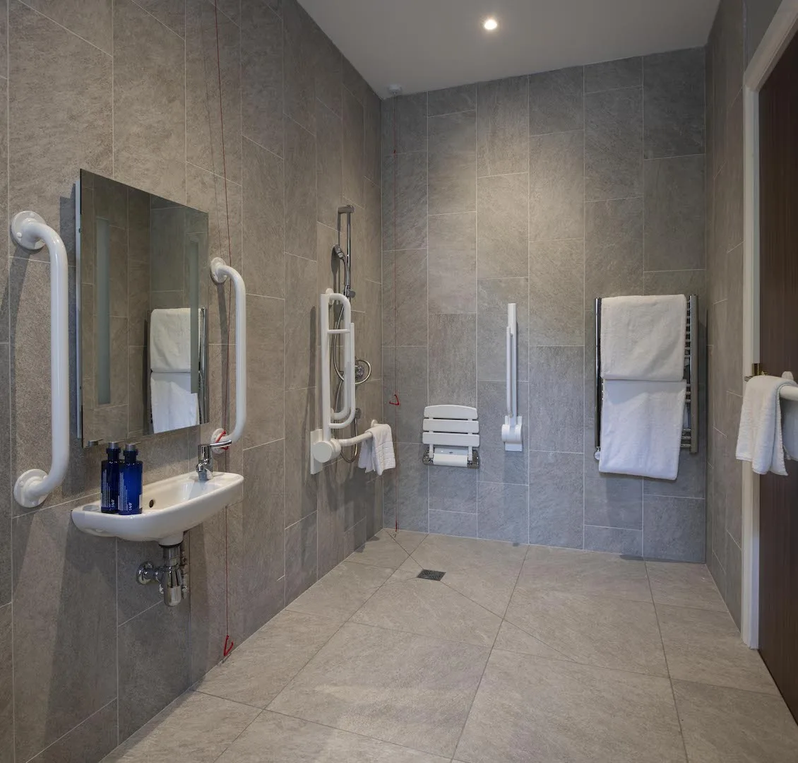 Accessible bathroom with modern fittings and gray tiles