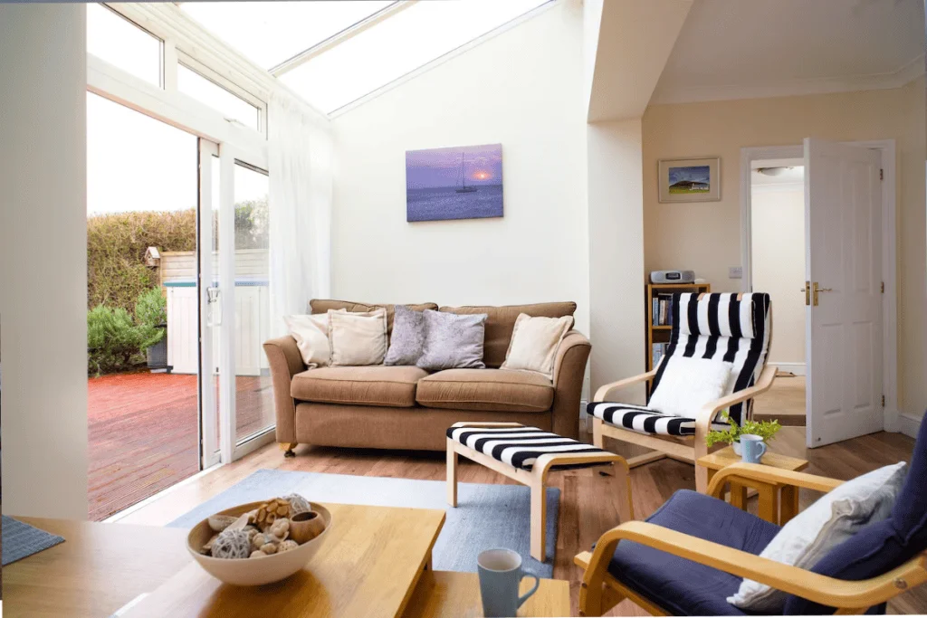 Bright living room with sofa and open patio door