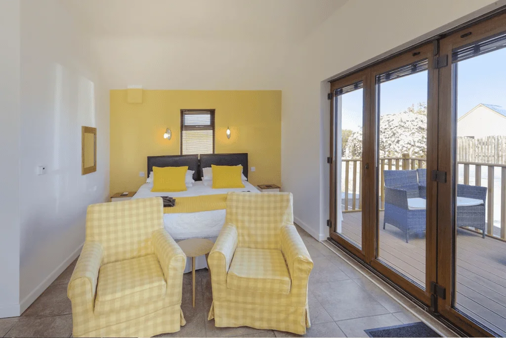 Bright bedroom with yellow accents and balcony access