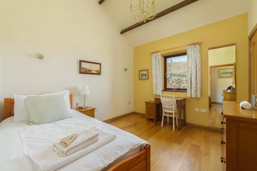 Cozy bedroom with scenic landscape view from window