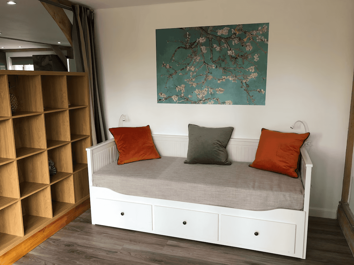 Cozy nook with bench, cushions, and wooden shelf