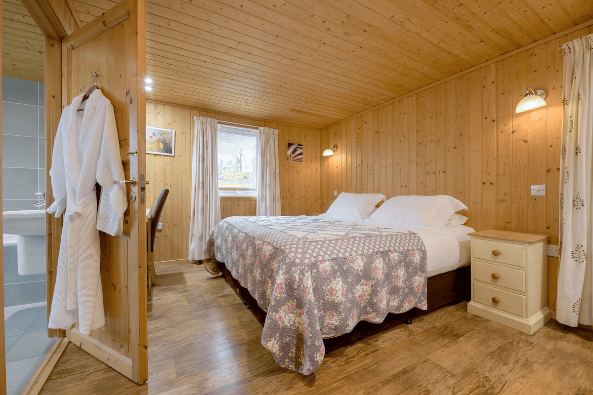 Cozy wooden cabin bedroom with scenic window view