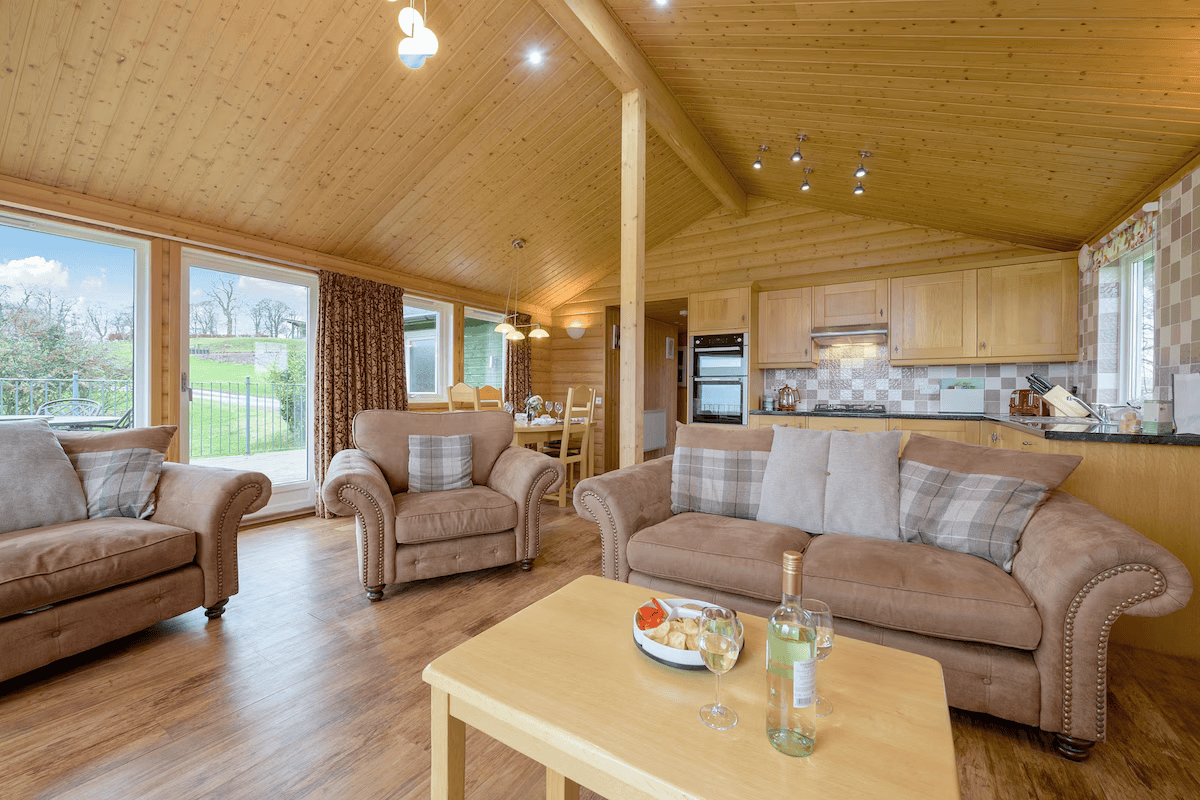 Cozy wooden cabin interior with comfortable seating and kitchen