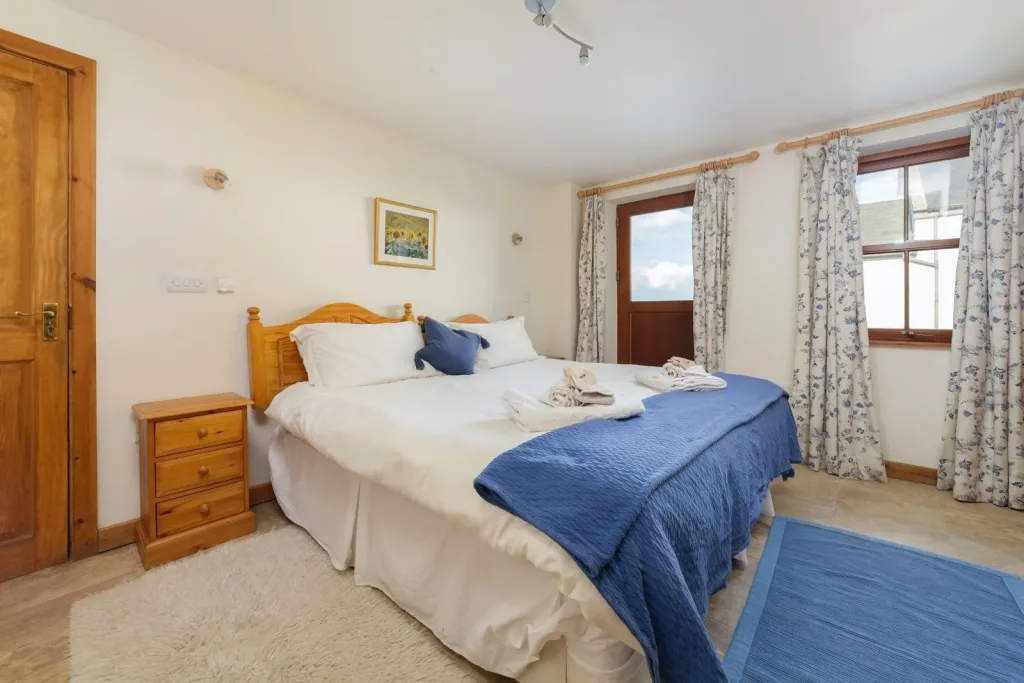 Cozy bedroom interior with wooden furniture and blue accents.