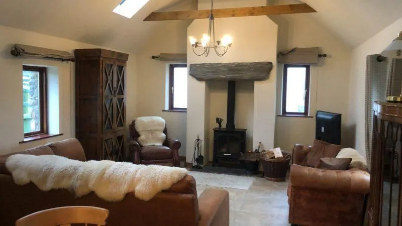 Cozy rustic living room with fireplace and wooden beams