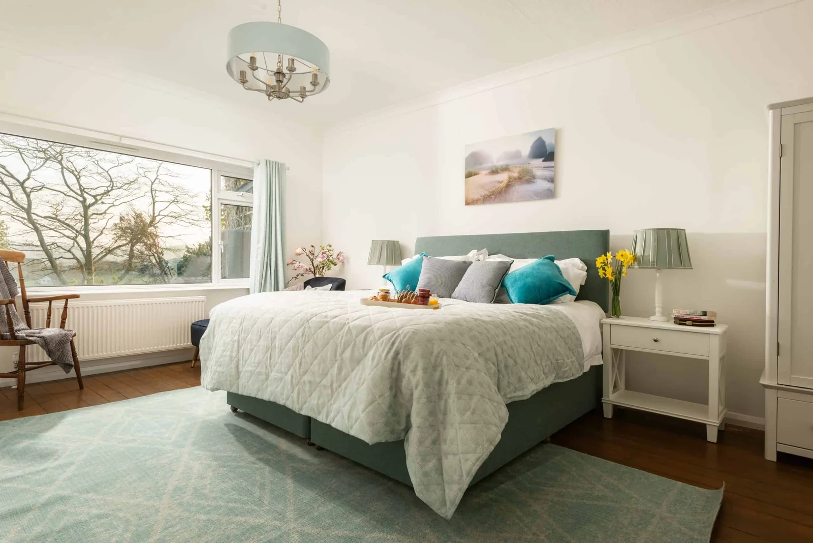 Cozy bedroom with large window and stylish decor