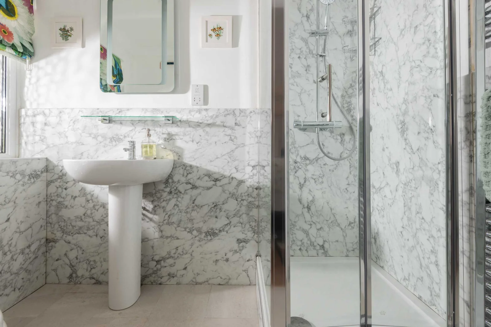 Modern bathroom with marble sink and glass shower
