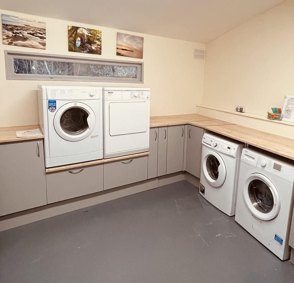 Clean laundry room with multiple washing machines