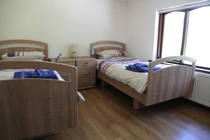 Simple twin bedroom with profiling beds and matching furniture
