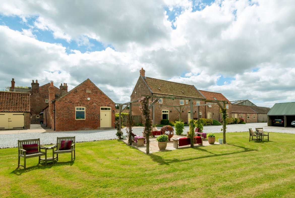 Charming countryside farm buildings under cloudy sky