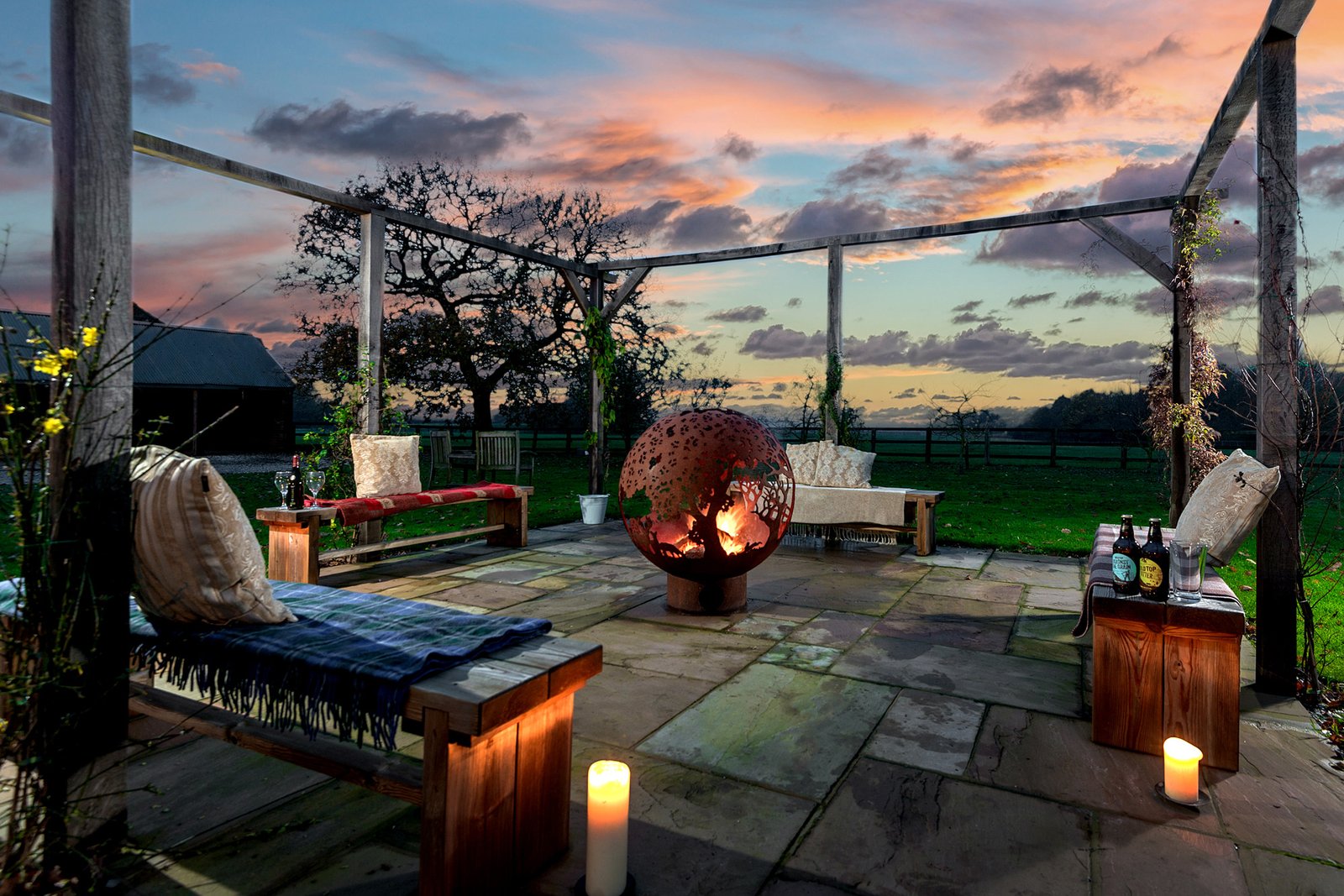 Patio with fire pit at sunset view.