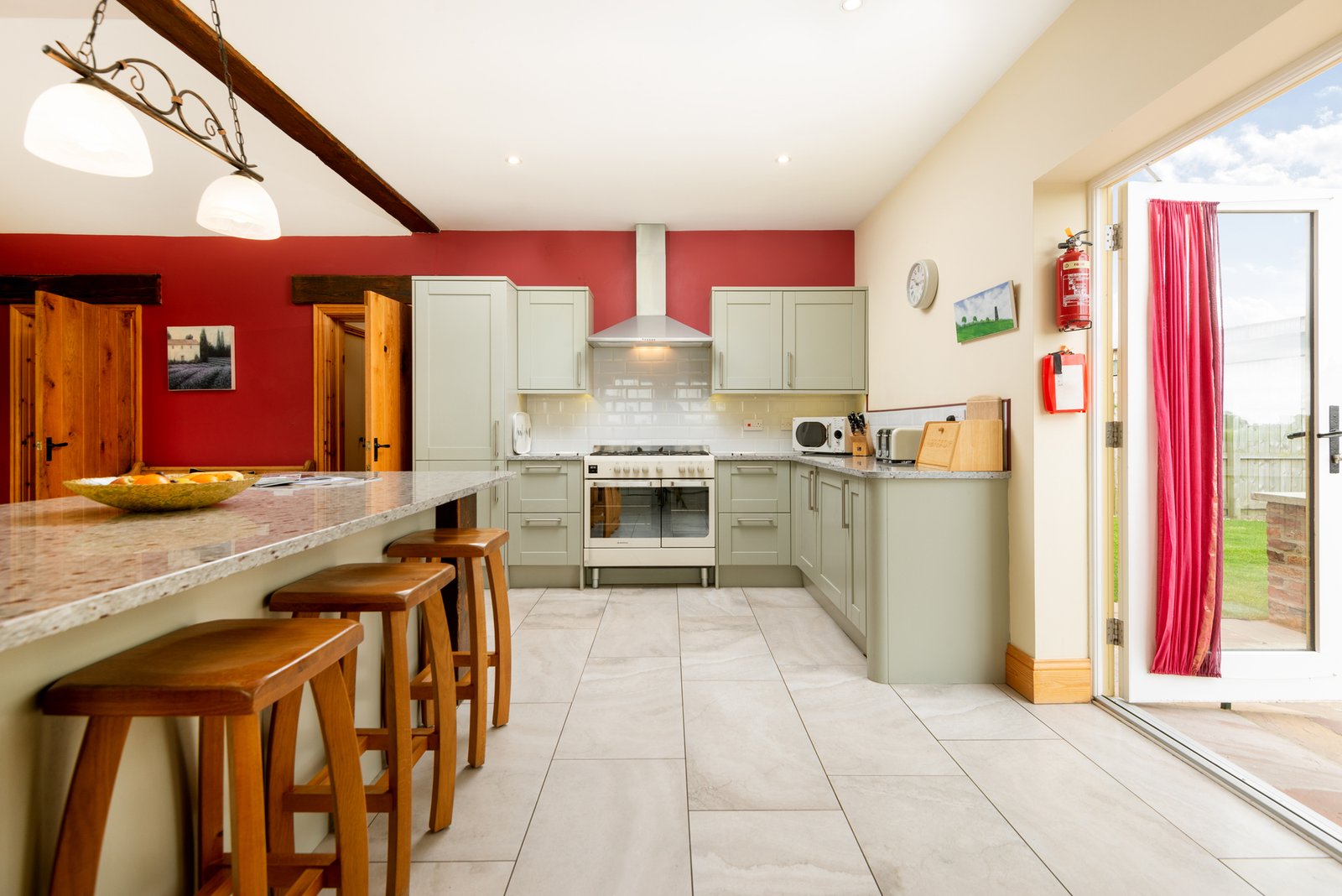 Spacious modern kitchen with island and stools.