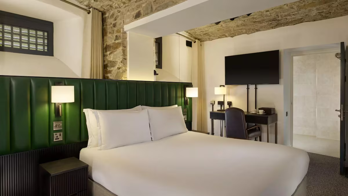 Modern hotel room with stone walls and desk