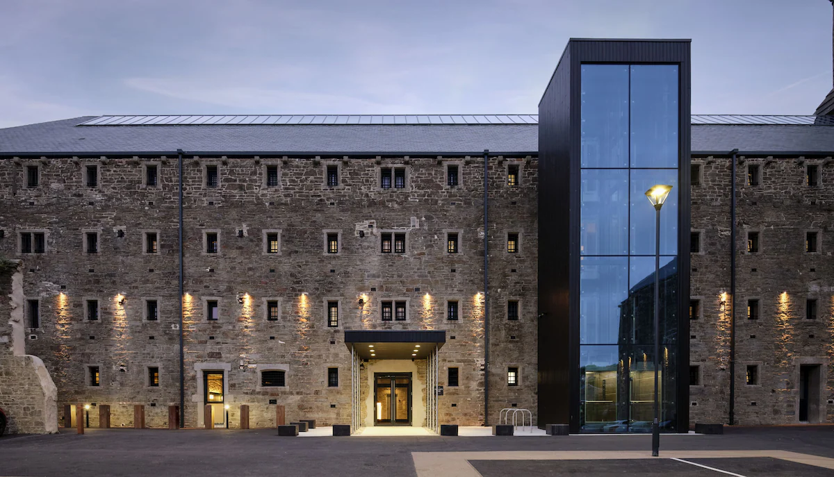 Historic brick building with modern glass extension.