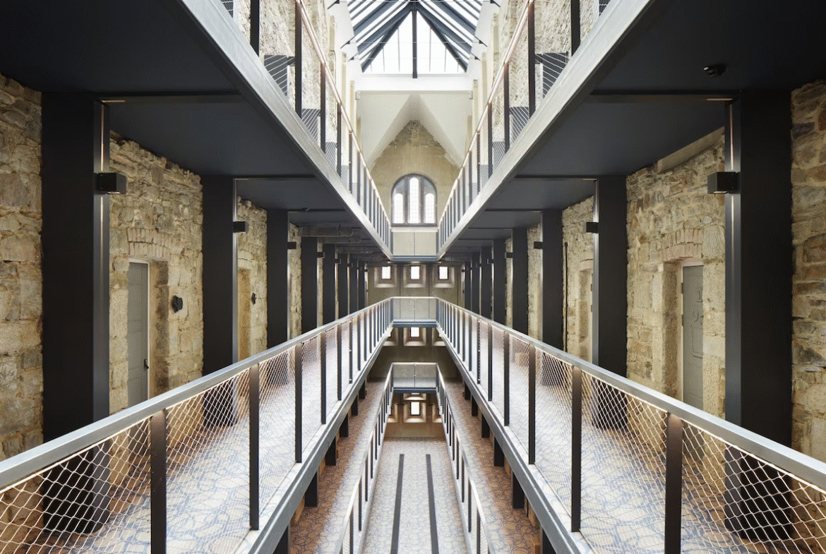 Modern industrial-style corridor with balconies and skylight.