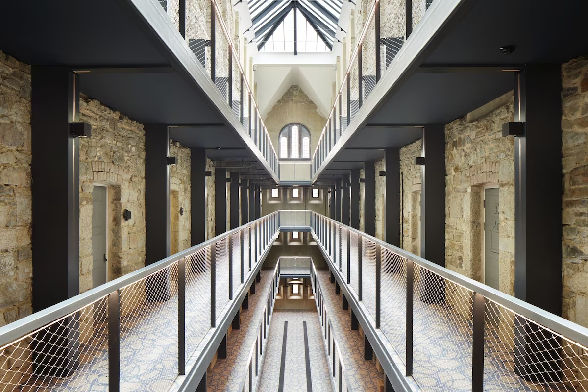 Modern industrial-style corridor with balconies and skylight.
