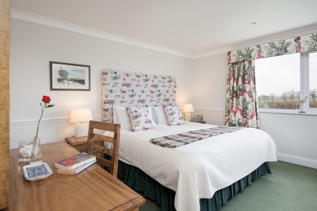 Cosy bedroom with rose and countryside view